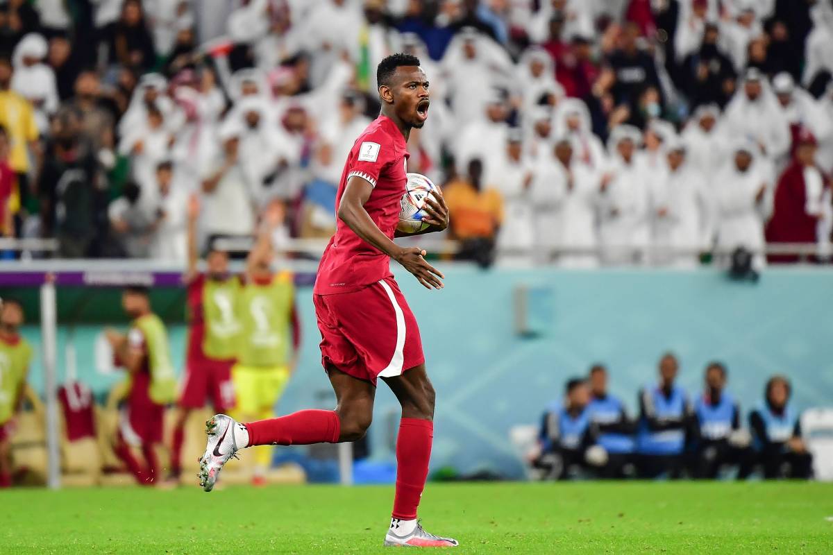 Mohammed Muntari pictured celebrating after scoring Qatar's first ever goal at a FIFA World Cup